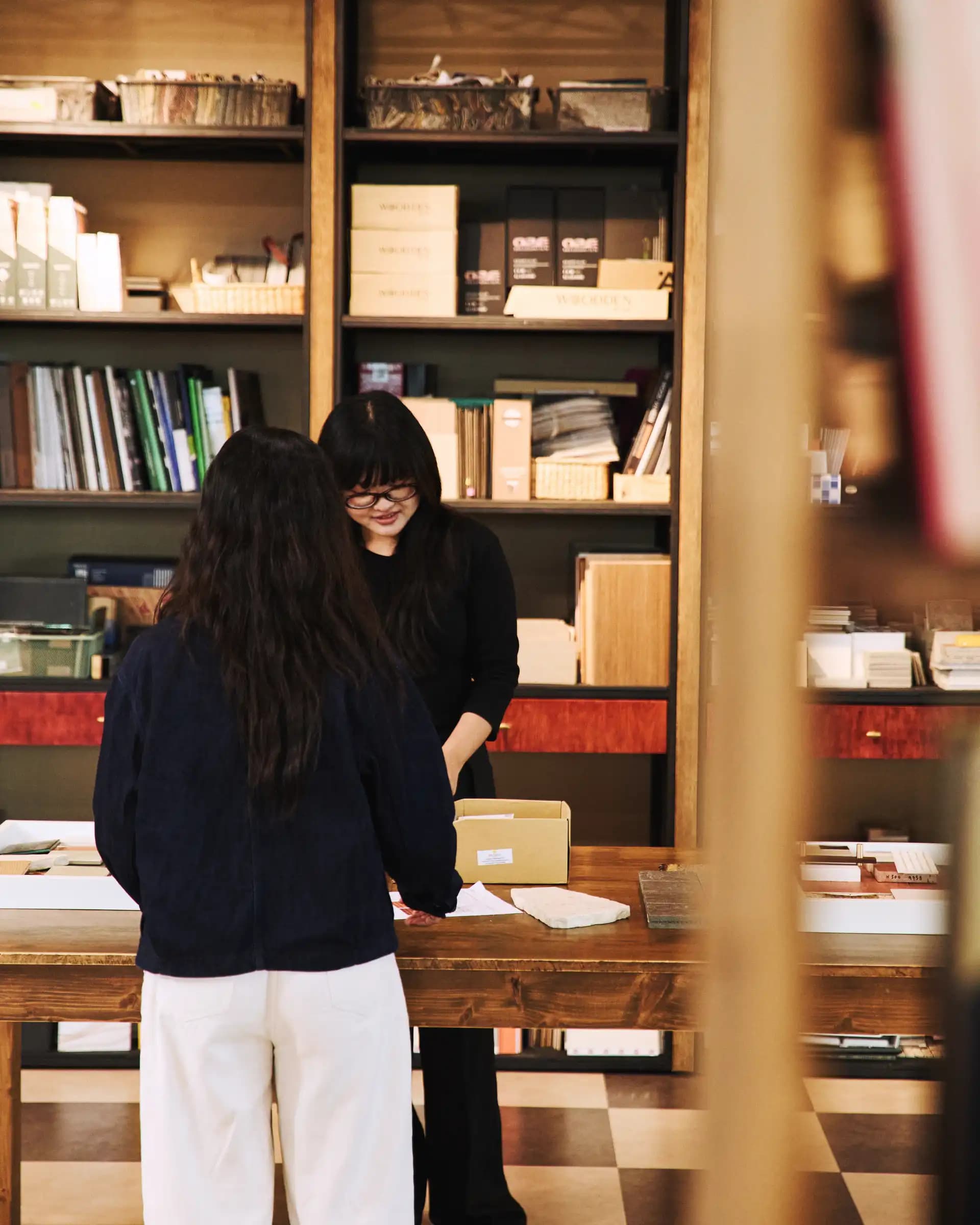 A designer examining furniture and material samples in a showroom
