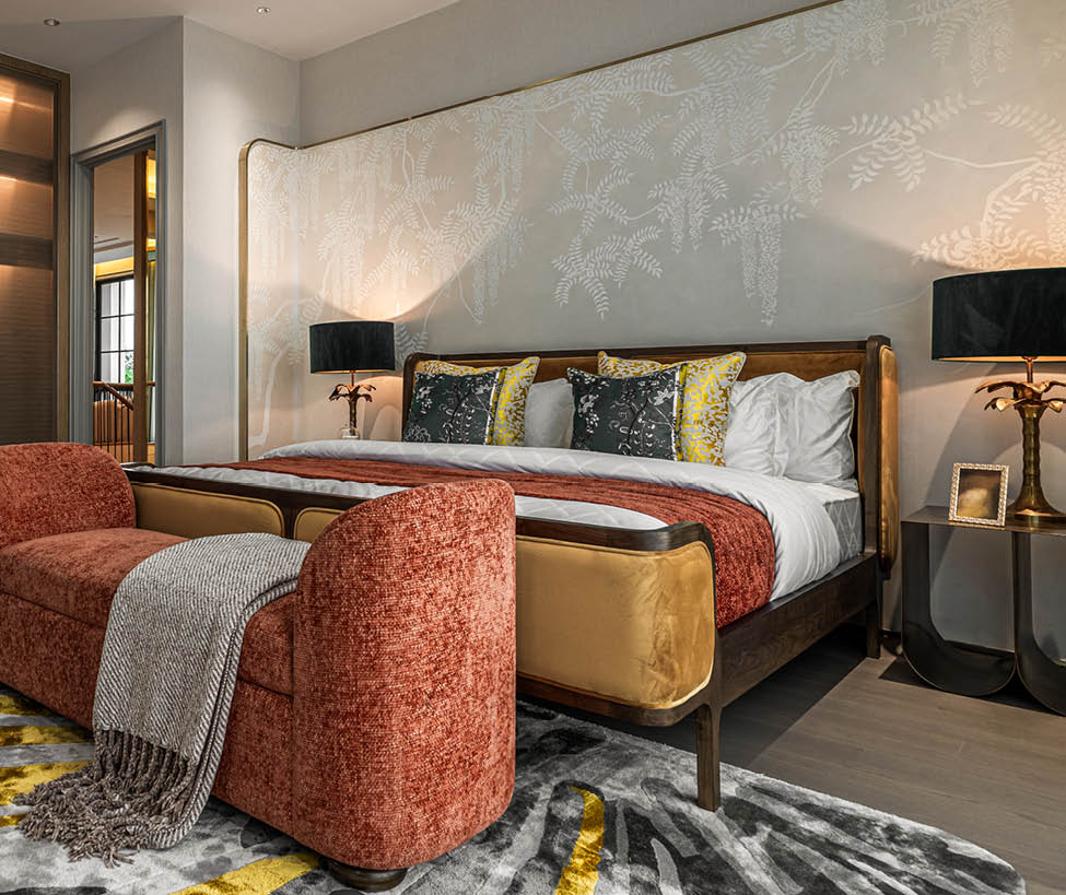 Master bedroom with floral wall painting and gold bedside lamps